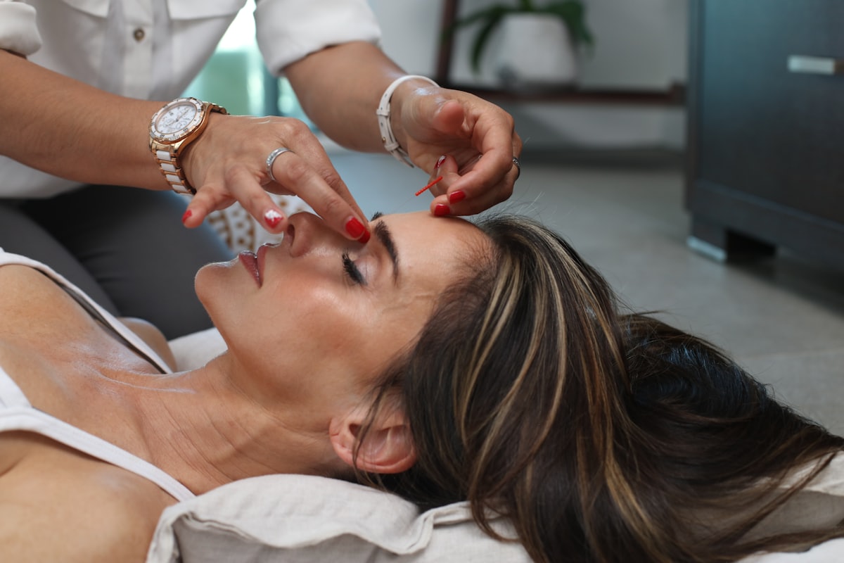 A practitioner treating a patient in a clinic room